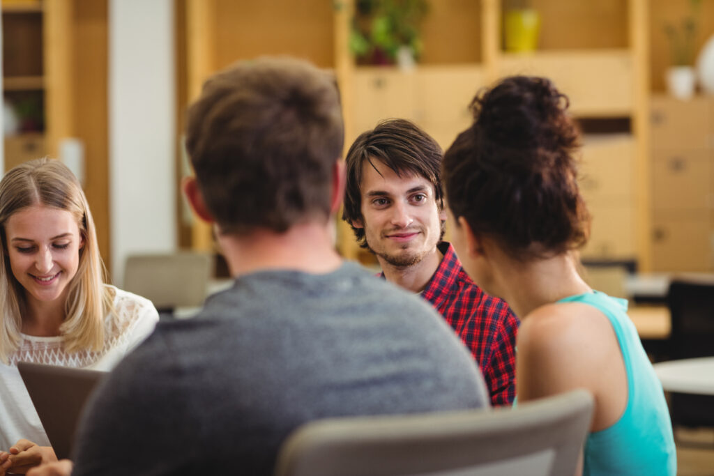 group of young people studying and talking