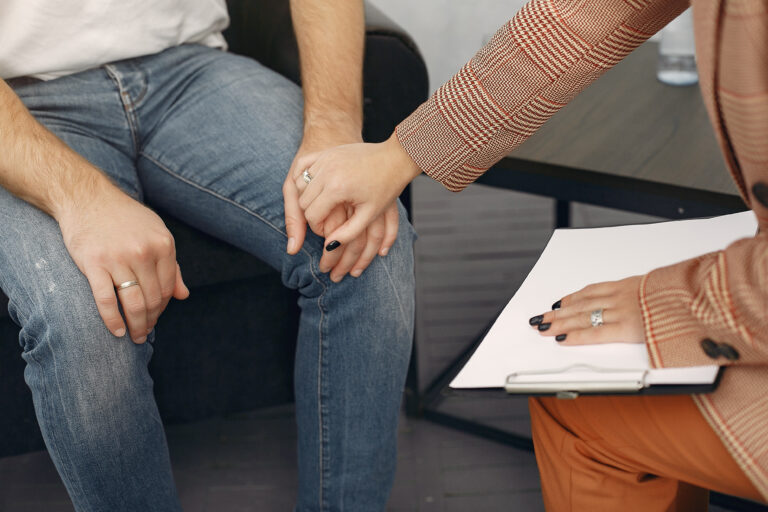 Doctor listening and advising patient while taking notes