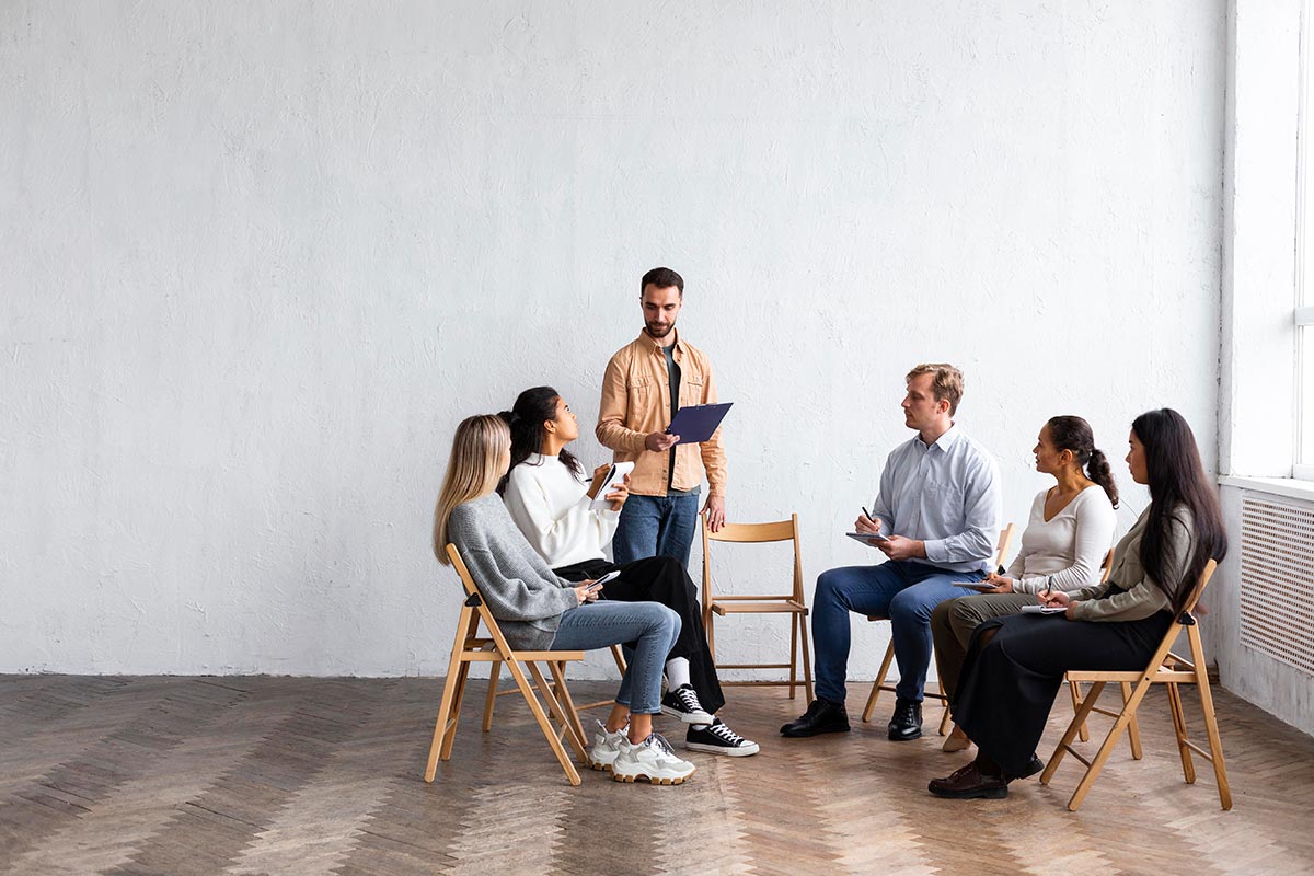 people attending group therapy session with copy space