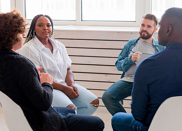 People in support circle telling their personal experiences